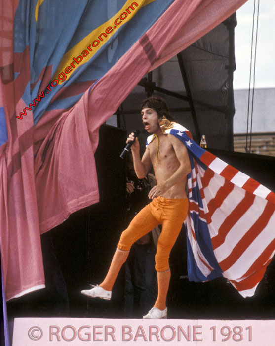 Draped in a Union Jack cape, Mick Jagger performs during an encore at Stones 